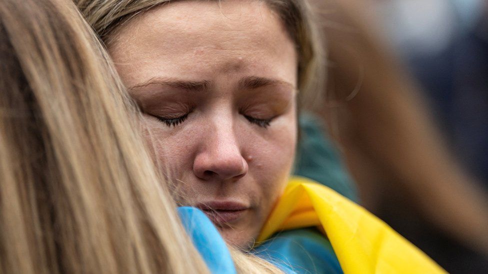 A woman cries during a march in support of Ukraine
