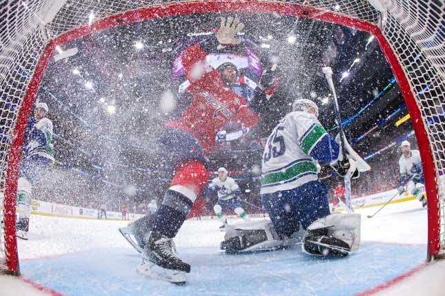 WASHINGTON, DC - FEBRUARY 11: Tom Wilson #43 of the Washington Capitals collides into the goal in front of goalie Thatcher Demko #35 of the Vancouver Canucks during the seco period at Capital One Arena on February 11, 2024 in Washington, DC. (Photo by Patrick Smith/Getty Images )